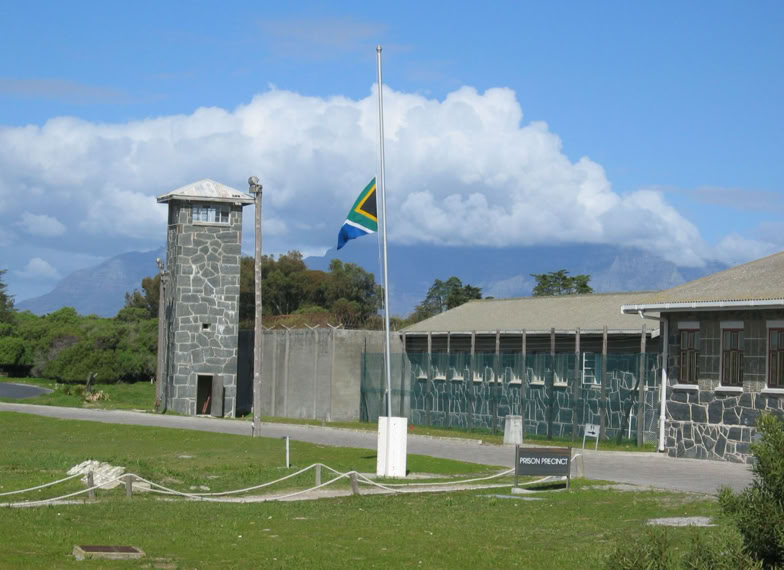 Flag pole outside the main entrance to the prison with flag at half mast.